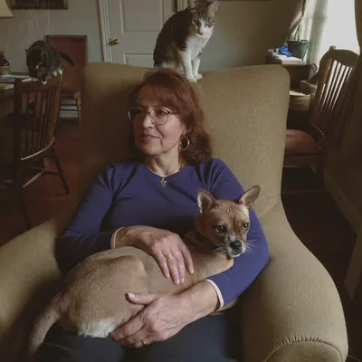 Pat W. at home with her cats and senior dog